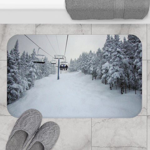 a pair of gray slippers sitting on top of a snow covered floor