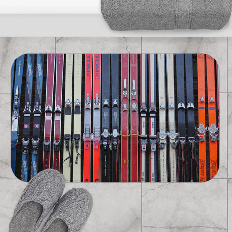 a pair of skis and ski poles on a tile floor