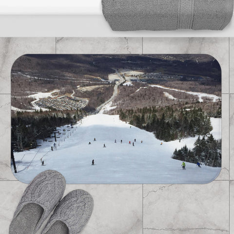 a pair of gray slippers sitting on top of a snow covered ground