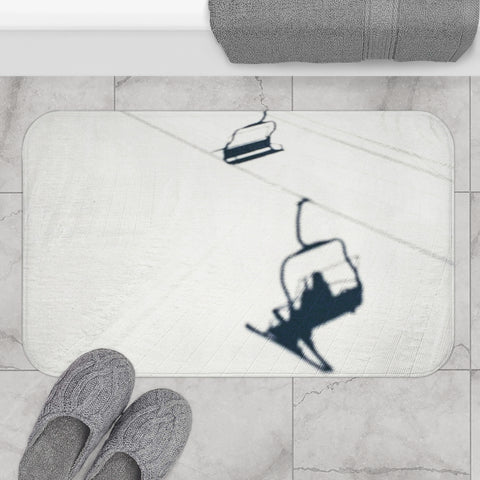 a pair of feet standing on a bathroom rug