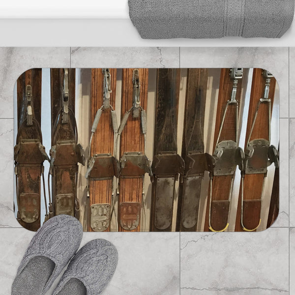 a pair of gray slippers sitting on top of a tile floor