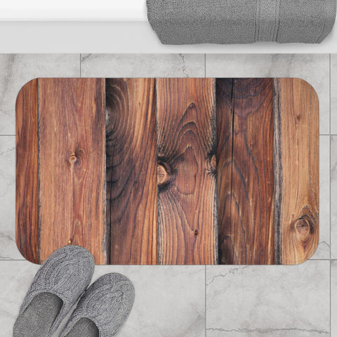 a pair of gray slippers sitting on top of a wooden floor