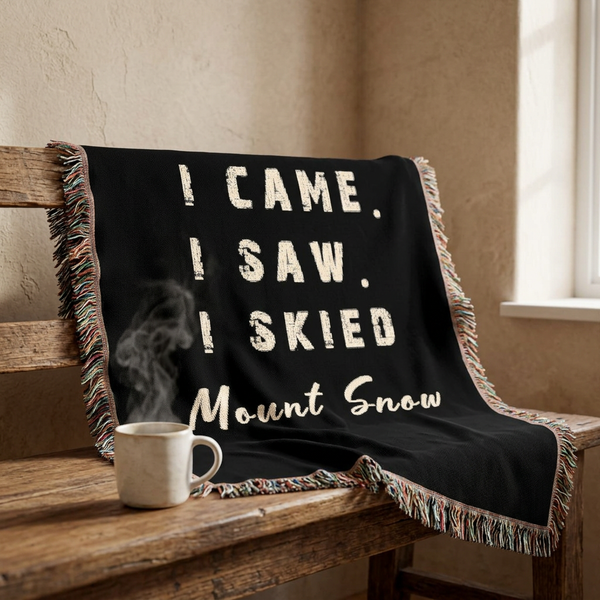 A black throw blanket with multicolor fringe and distressed white text reading 'I CAME. I SAW. I SKIED MOUNT SNOW