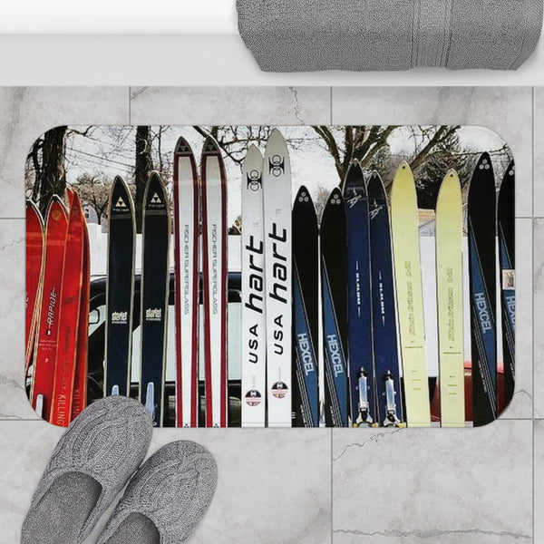 a pair of gray slippers sitting on top of a floor covered in skis