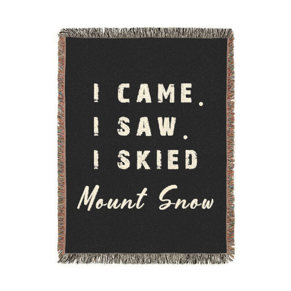 A rectangular black throw blanket with fringed edges, featuring the phrase 'I CAME. I SAW.