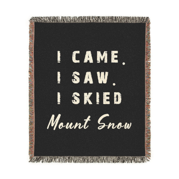 A square black woven throw blanket with multicolor fringe, featuring the text 'I CAME. I SAW.