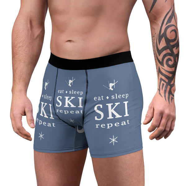a man with a tattoo on his arm wearing a pair of ski boxer shorts