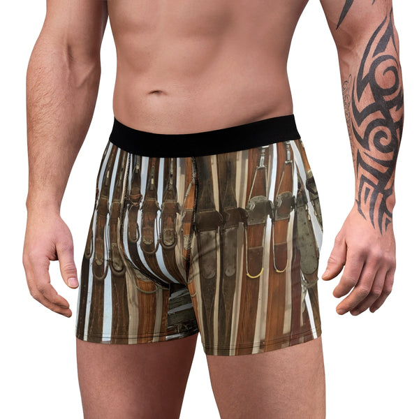 a man with a tattoo on his arm wearing a pair of boxer shorts