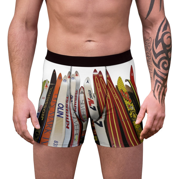 a man with a tattoo on his arm wearing a pair of swim trunks