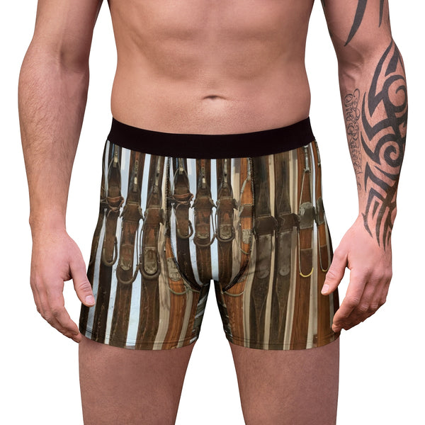 a man with a tattoo on his arm wearing a pair of boxer shorts